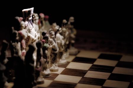 Chess pieces on board with King spotlitの写真素材