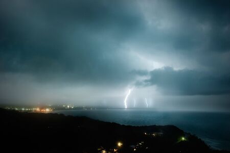 Lightning strikes several spots on the coastの写真素材