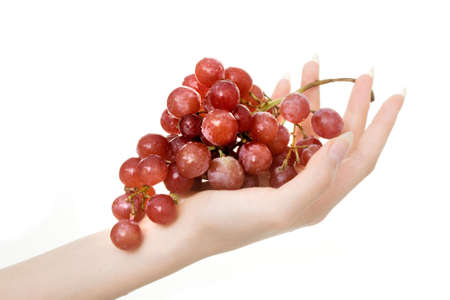 Hand holding bunch of grapes isolated on white backgroundの写真素材