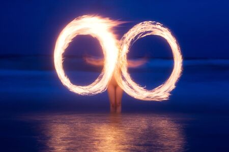  model fire twirls on beachの写真素材