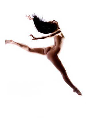 Silhouette of nude body performing dance moveの写真素材