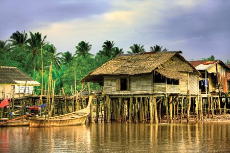 Wooden shanties built along a river in Asiaの写真素材