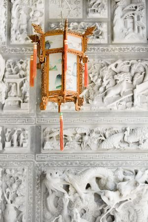 Chinese lantern in front of grey carved stone backgroundの写真素材