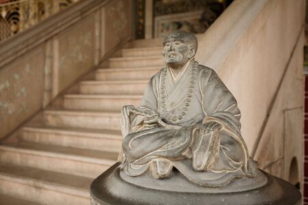 One of a pair of staircase statues, this one sad, the other happyの写真素材