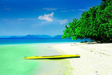 Kayak on white sandy beach in tropical paradiseの写真素材