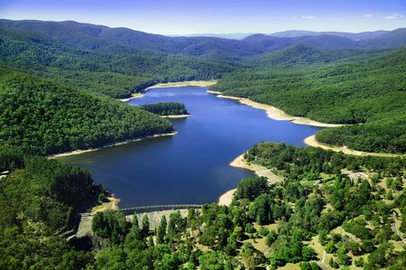 Aerial photo of dam in between mountainsの写真素材