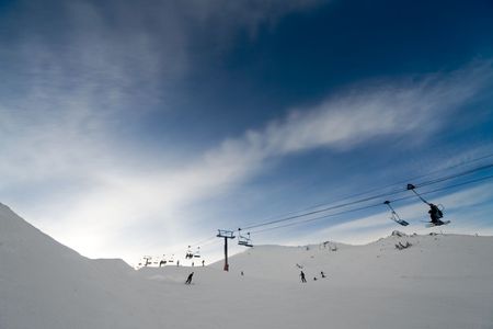 Alpine scenic with deep blue sky, whie snow and chair liftの写真素材