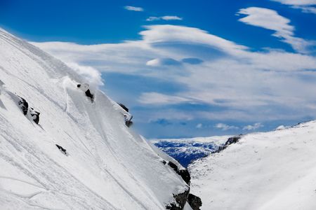 Snowboarder puts in powder carve high on mountainの写真素材