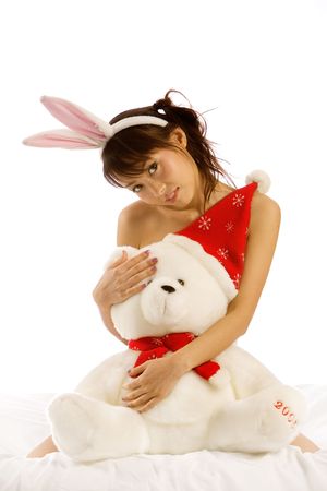 Sexy Asian woman plays with Christmas teddy bearの写真素材