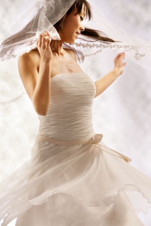 Bride dressing in white spins around happyの写真素材