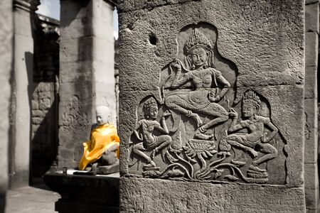 Stone carving of dancing girl on temple ruinsの写真素材