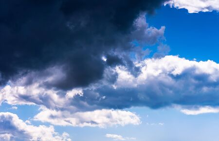 Blue sky with clouds from white to blackの写真素材
