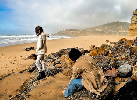 A woman with a teenage girl near the beachの写真素材