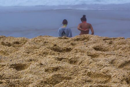 Two women on a beach in the fogの写真素材