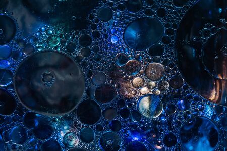 Oil drops on the surface of the waterの写真素材