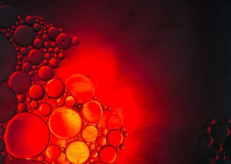 Oil drops on the surface of the waterの写真素材