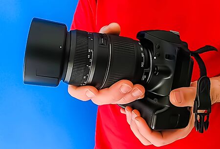 Man in red shirt with camera in actionの写真素材