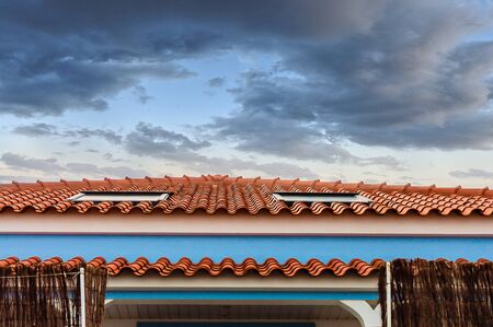Roof house with tiles in perspective to the skyの写真素材