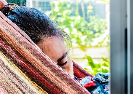 The face of a woman resting in a hammockの写真素材