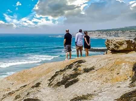Looking at the ocean gives you peace and quiet, these weekend tourists show itの写真素材