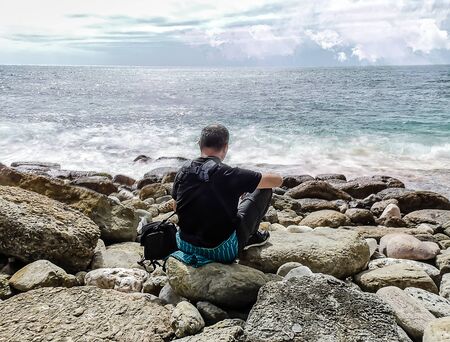 Looking at the sea, alone in peace, always gives you peace and freedomの写真素材