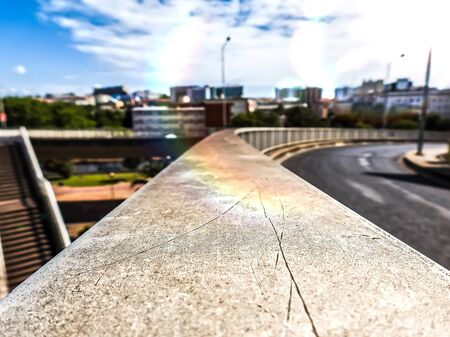 City view from a metal railing with the city in blurred perspectiveの写真素材