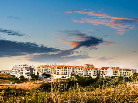 View with a residential neighborhood near the sunset with a sky with fine and colorful cloudsの写真素材