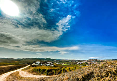 Autumn landscape from the village with intense blue sky and some white cloudsの写真素材