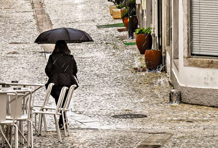 People with umbrella in the rain on a street in the old center ofの写真素材