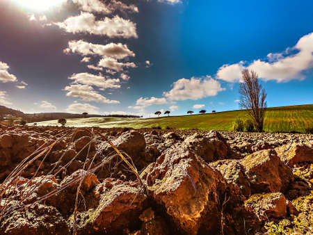 Landscape with a plowed field on the edge of a village in Portugalの写真素材