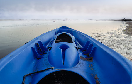 View from a blue canoe to a foggy horizonの写真素材