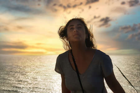 Adult woman enjoying nature in the sunset light