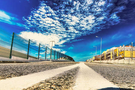 View from a sloping street with a sky of definite cloudsの写真素材