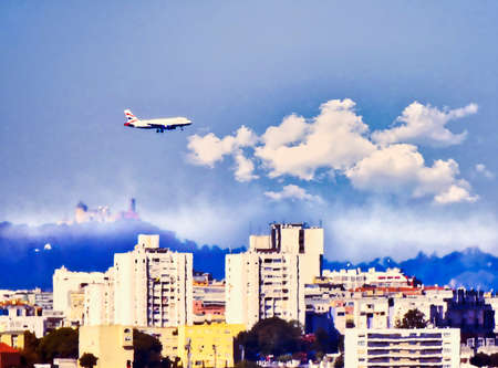 Plane over the city on landing with cloudy skiesの写真素材
