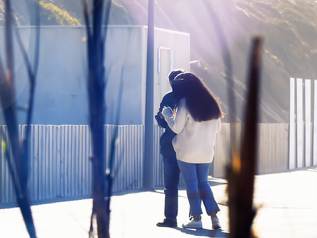 A couple looking at the cell phone on the seafront