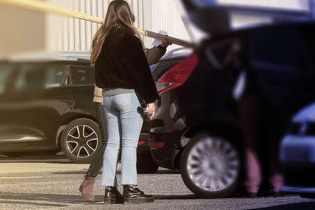 Woman in a parking lot going shopping in a store