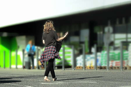 Woman in a parking lot going shopping in a storeの写真素材