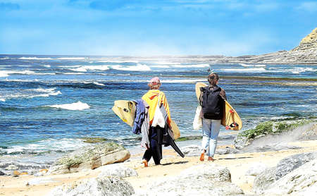 A pair of surfers marching on the beach at duskの写真素材