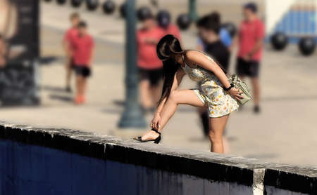 The young woman in the yellow dress on the streetの写真素材