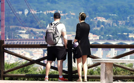A couple admiring the view across a riverの写真素材
