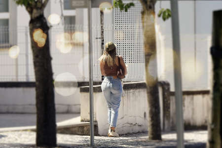 Blond woman walking on the street in the city