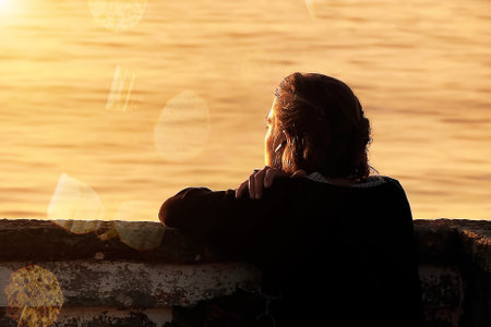 People enjoying the spectacle of the sunset at the Atlantic oceanの写真素材