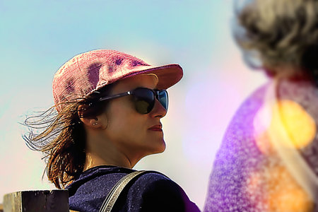 Adult woman with sunglasses in the sunset lightの写真素材