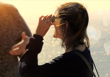 Adult woman with sunglasses in the sunset light