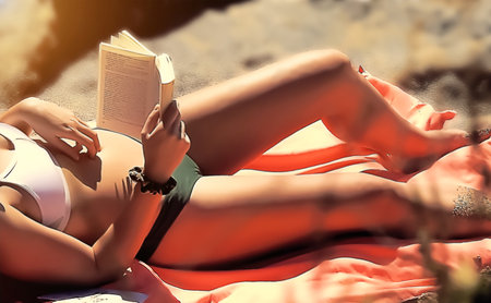 In a bikini lying on the sand enjoying the sun