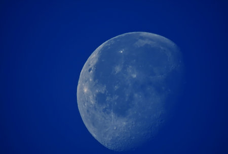 Daytime view of the almost full moonの写真素材