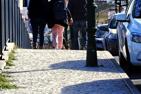 A family on a cobblestone sidewalkの写真素材