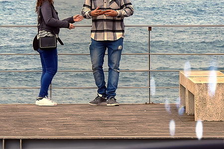 A couple taking pictures with their mobile phoneの写真素材