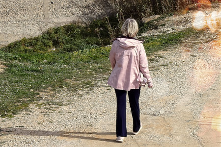 Adult woman walking on a pathの写真素材
