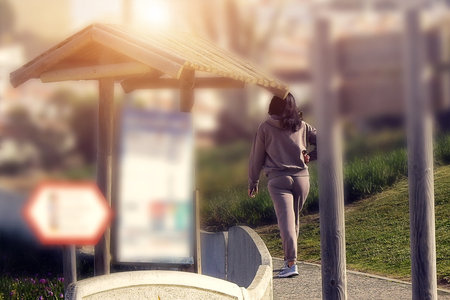 Woman in sports equipment walking in the morningの写真素材